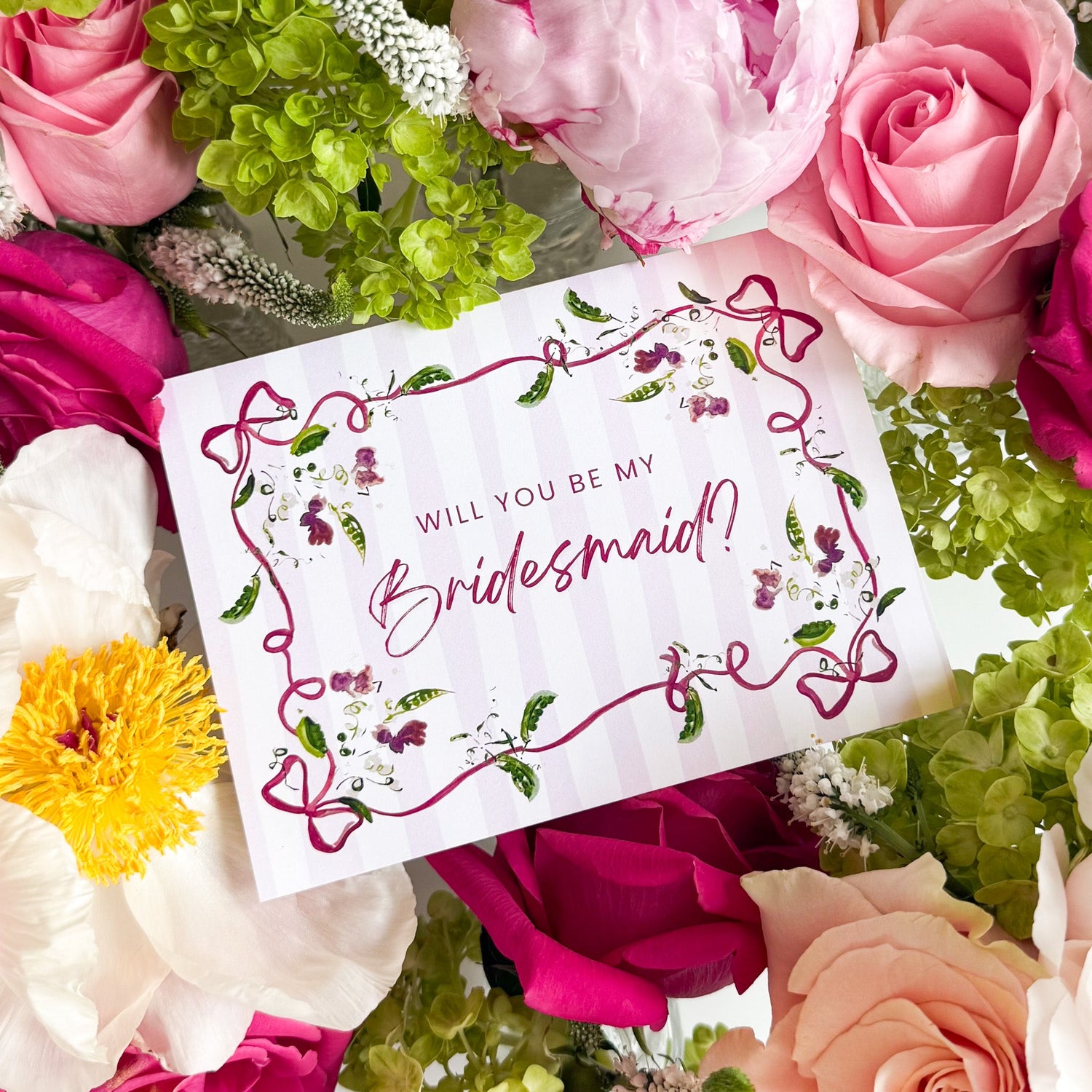 Floral bridesmaid proposal card surrounded by wedding flowers