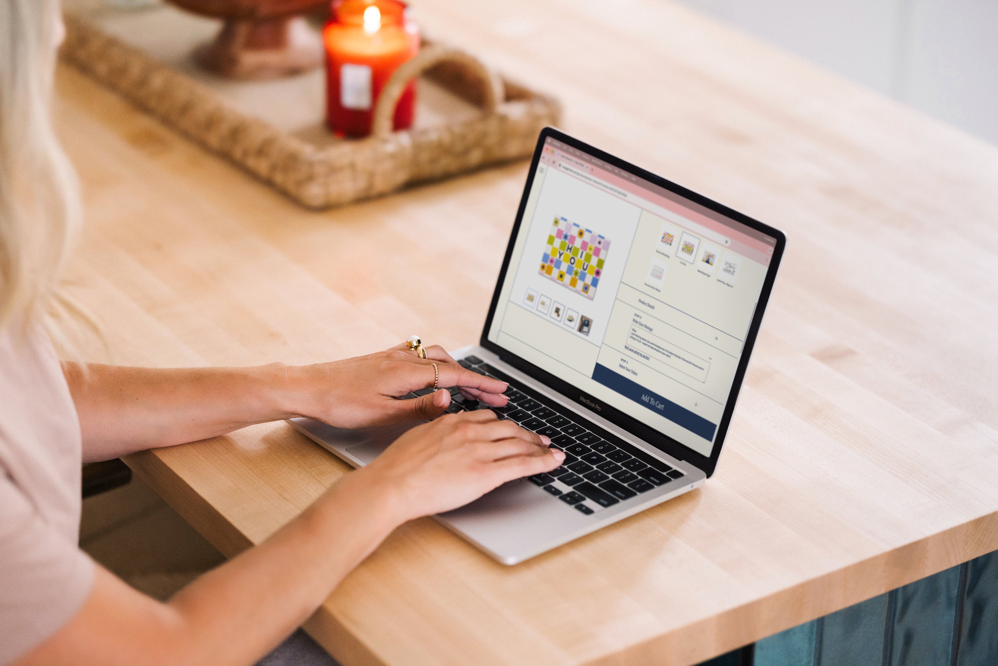 Woman sitting at a laptop computer, creating a personalized Token Moment gift from Truly Gifted.